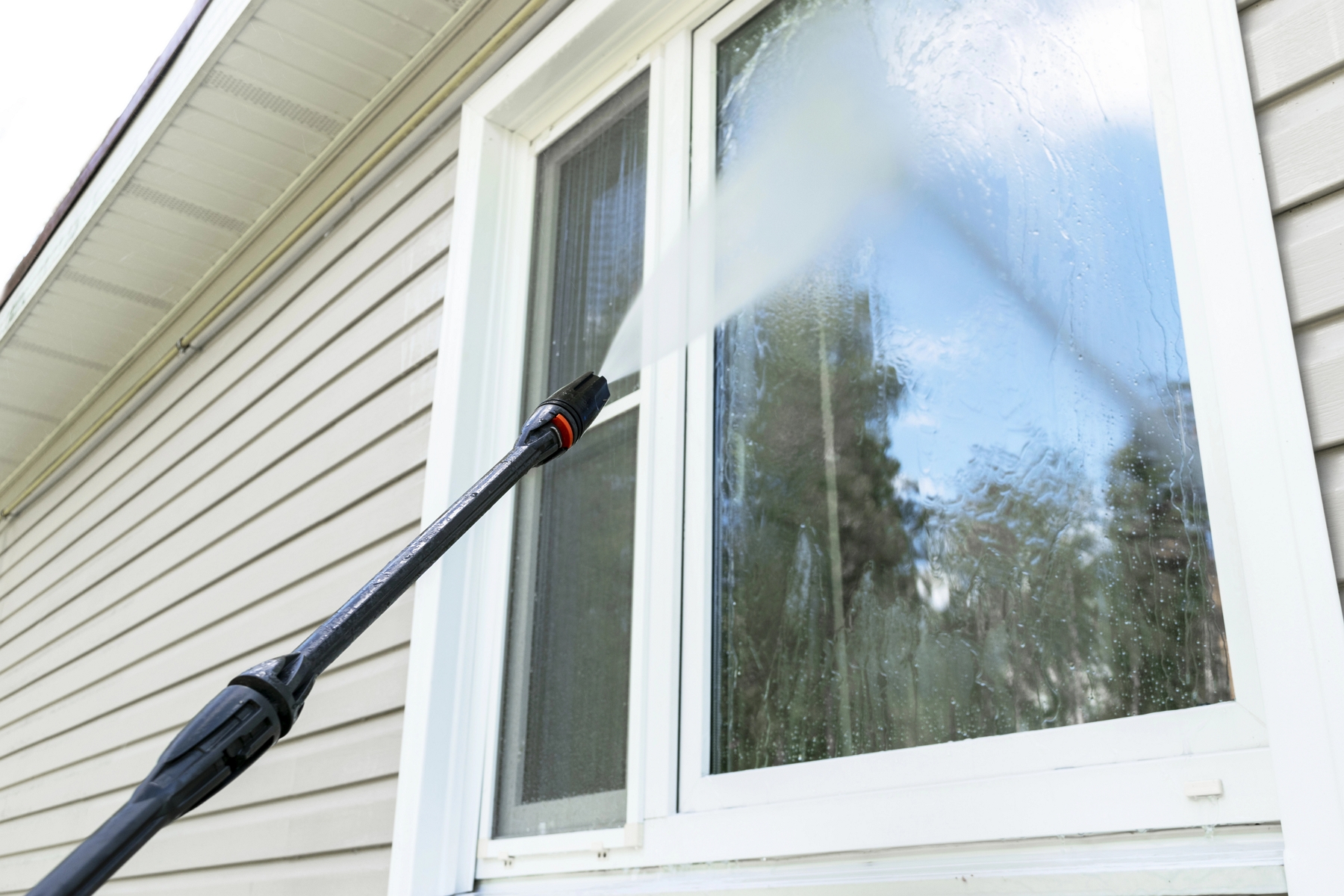 Pressure washing a window and siding