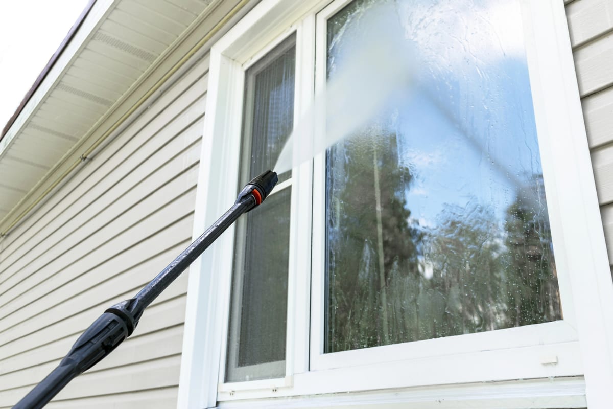 Pressure washing a window and siding